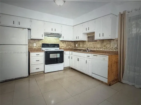 a kitchen with stainless steel appliances a stove sink and refrigerator