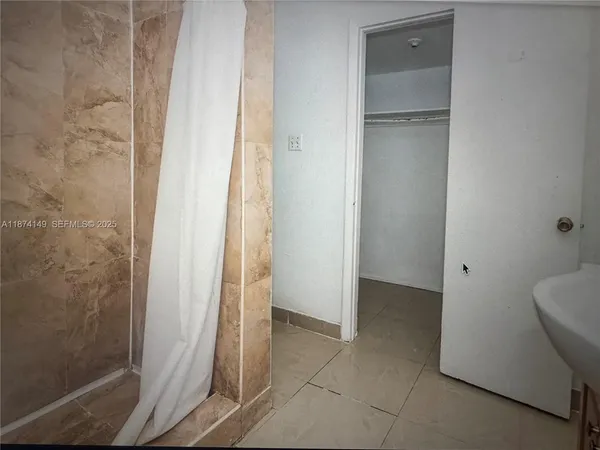 a view of an empty room with wooden door