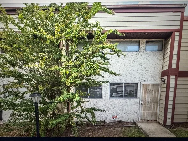 a house that has a tree in front of the house