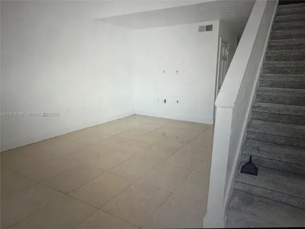 a view of an empty room with stairs