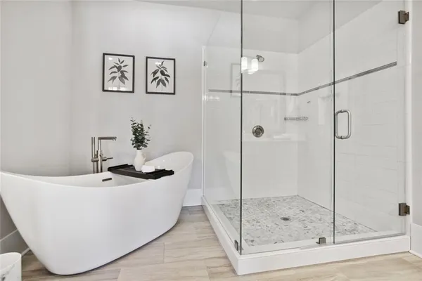 a white bath tub sitting next to a bathroom sink