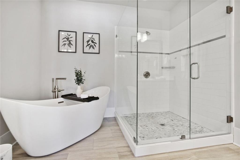 692 Drewry Street Northeast Atlanta, GA 30306 - Photo 13 of 25 a white bath tub sitting next to a bathroom sink