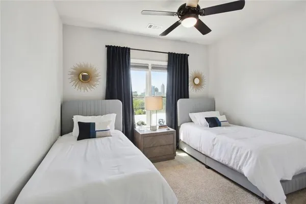 a bedroom with a large bed and a window