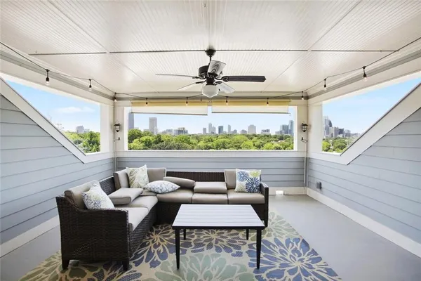 a view of a balcony with furniture and a floor to ceiling window