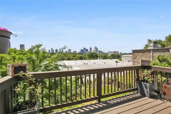 a balcony with wooden floor and city view