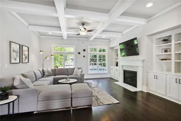 a living room with furniture a flat screen tv and a fireplace
