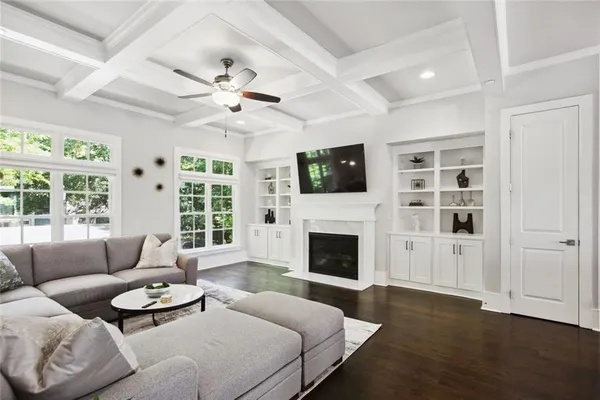 a living room with furniture a flat screen tv and a fireplace