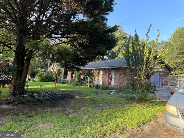 a view of a big yard next to a house