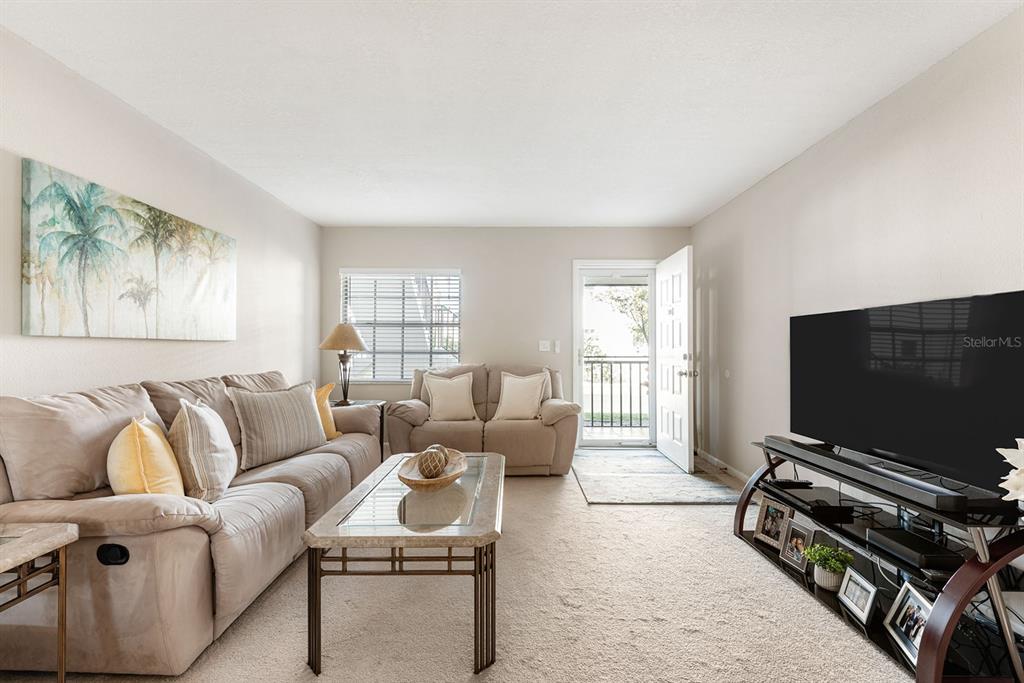 1531 Placida Road, Unit 8101 Englewood, FL 34223 - Photo 11 of 76 a living room with furniture and a flat screen tv