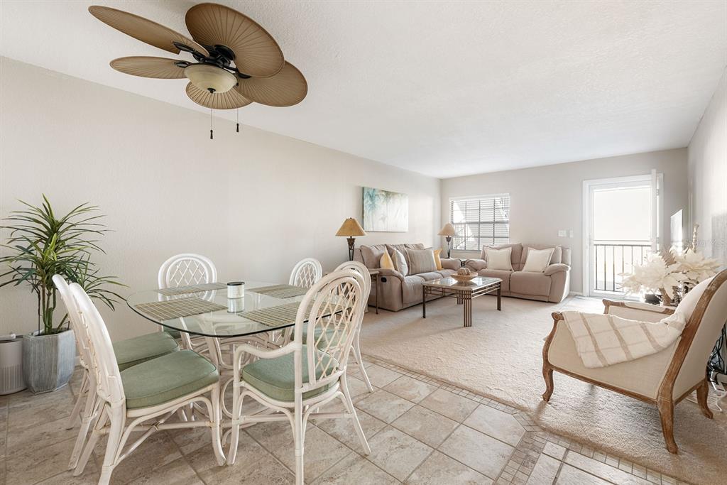 1531 Placida Road, Unit 8101 Englewood, FL 34223 - Photo 15 of 76 a living room with furniture a chandelier and a window