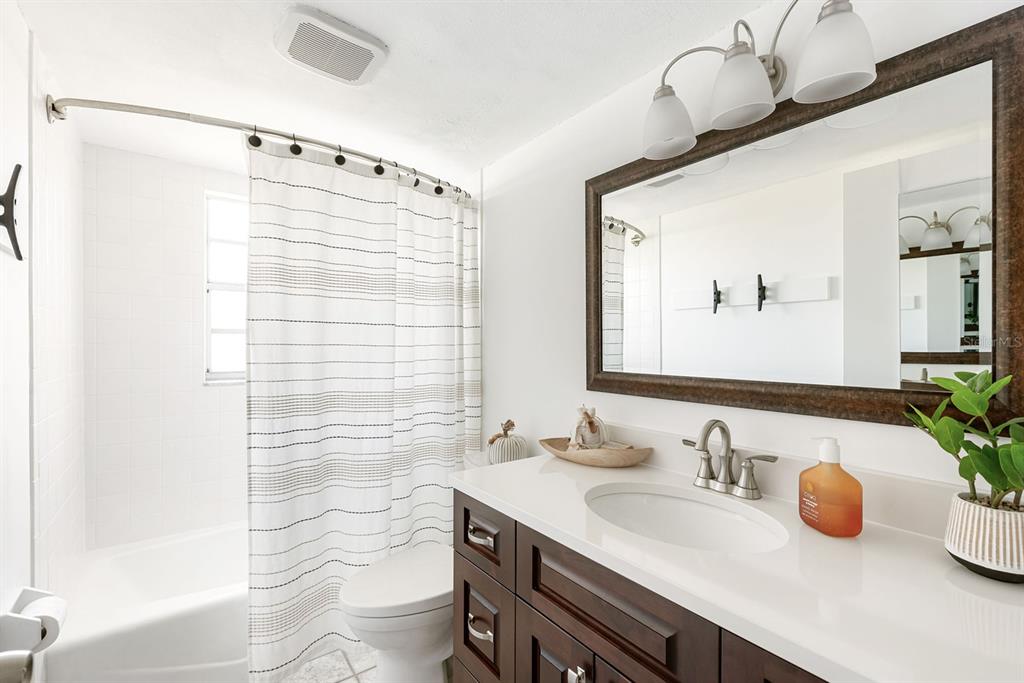1531 Placida Road, Unit 8101 Englewood, FL 34223 - Photo 20 of 76 a bathroom with a granite countertop sink and a mirror