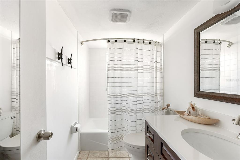 1531 Placida Road, Unit 8101 Englewood, FL 34223 - Photo 21 of 76 a bathroom with a granite countertop sink toilet and shower