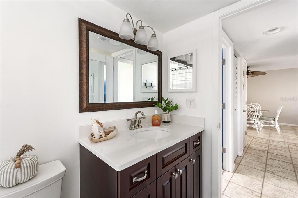 1531 Placida Road, Unit 8101 Englewood, FL 34223 - Photo 22 of 76 a bathroom with a sink and a mirror