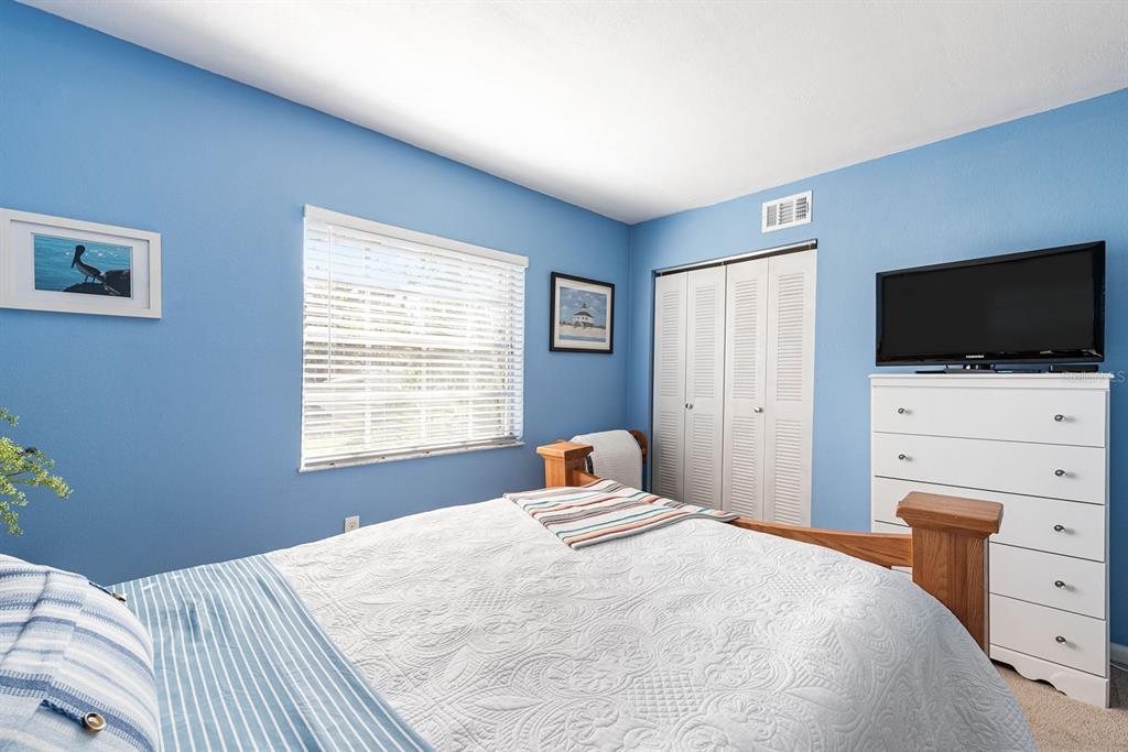 1531 Placida Road, Unit 8101 Englewood, FL 34223 - Photo 25 of 76 a bedroom with a bed and a flat screen tv