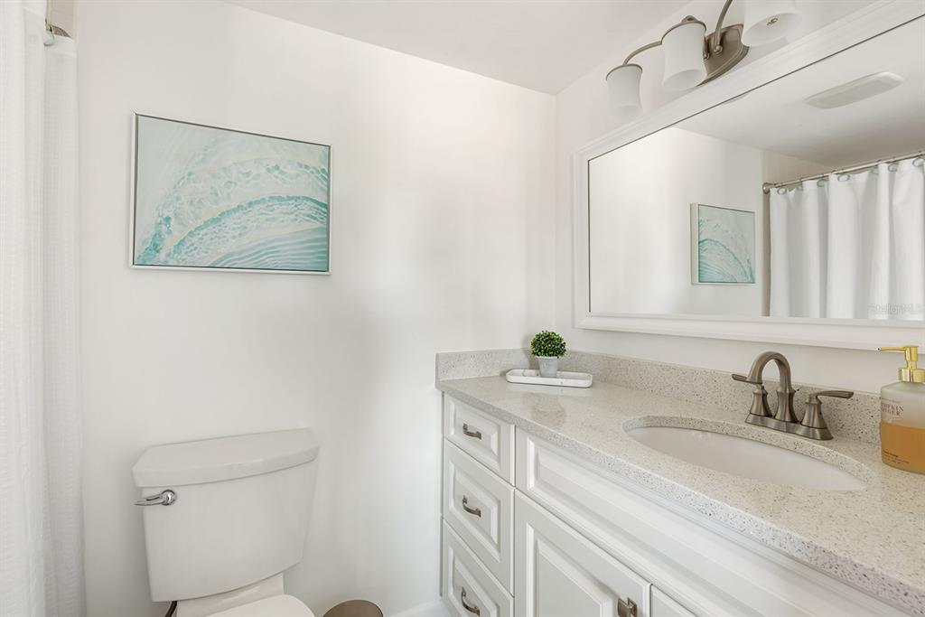 1531 Placida Road, Unit 8101 Englewood, FL 34223 - Photo 29 of 76 a bathroom with a granite countertop sink mirror and toilet