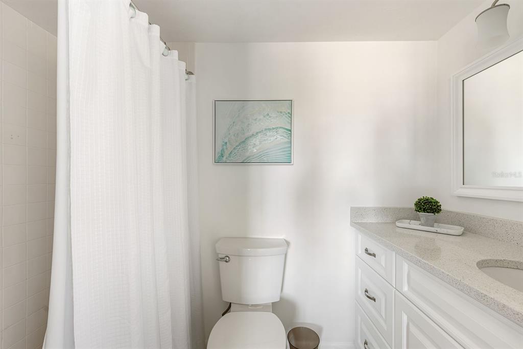 1531 Placida Road, Unit 8101 Englewood, FL 34223 - Photo 30 of 76 a bathroom with a toilet sink and mirror