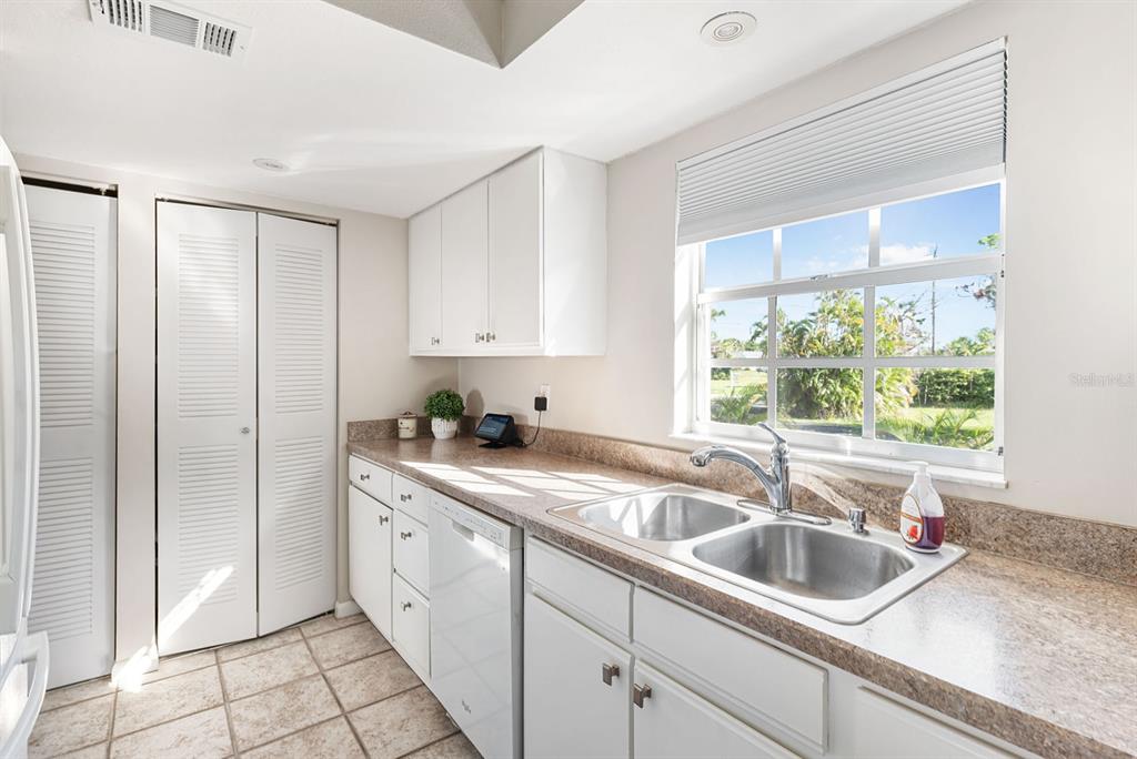 1531 Placida Road, Unit 8101 Englewood, FL 34223 - Photo 35 of 76 a kitchen with a sink cabinets and window