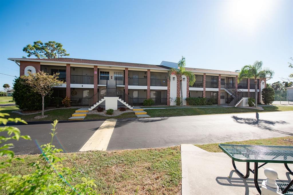 1531 Placida Road, Unit 8101 Englewood, FL 34223 - Photo 42 of 76 a view of a house with backyard and sitting area