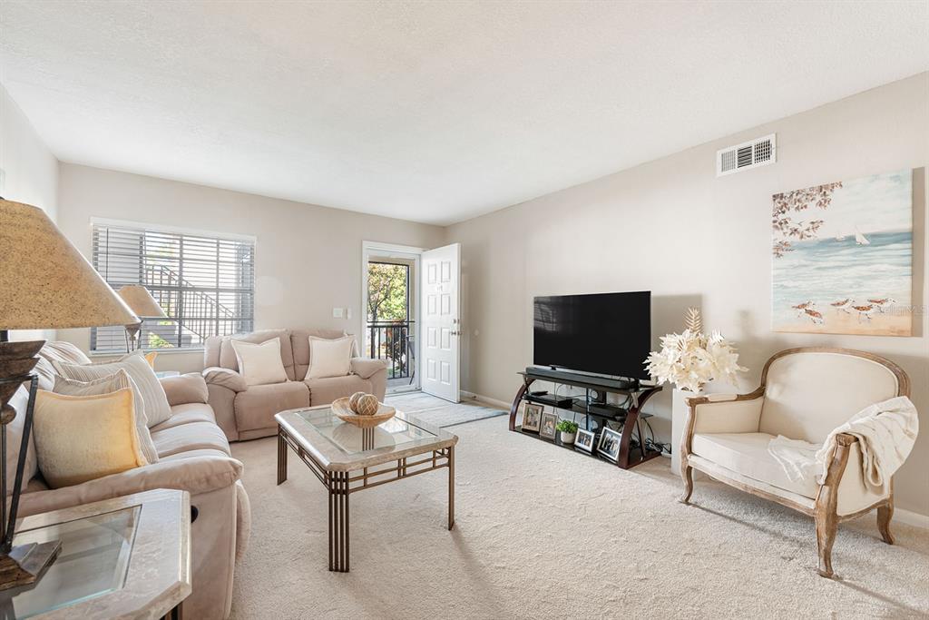 1531 Placida Road, Unit 8101 Englewood, FL 34223 - Photo 10 of 76 a living room with furniture and a flat screen tv