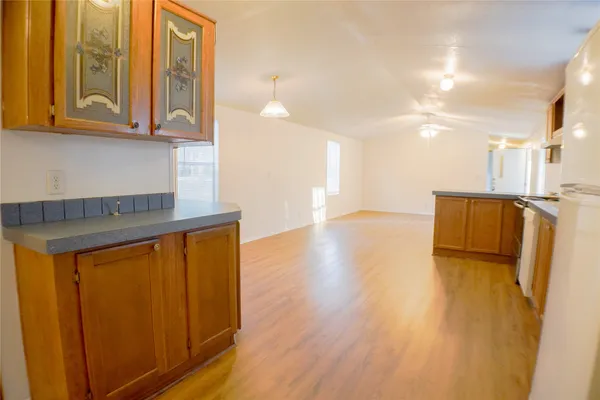 a view of kitchen with stainless steel appliances granite countertop cabinets and wooden floor