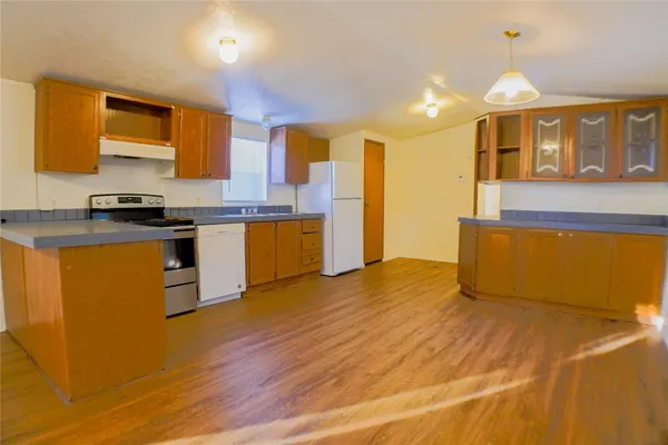 a kitchen with stainless steel appliances granite countertop a stove a sink dishwasher and a refrigerator