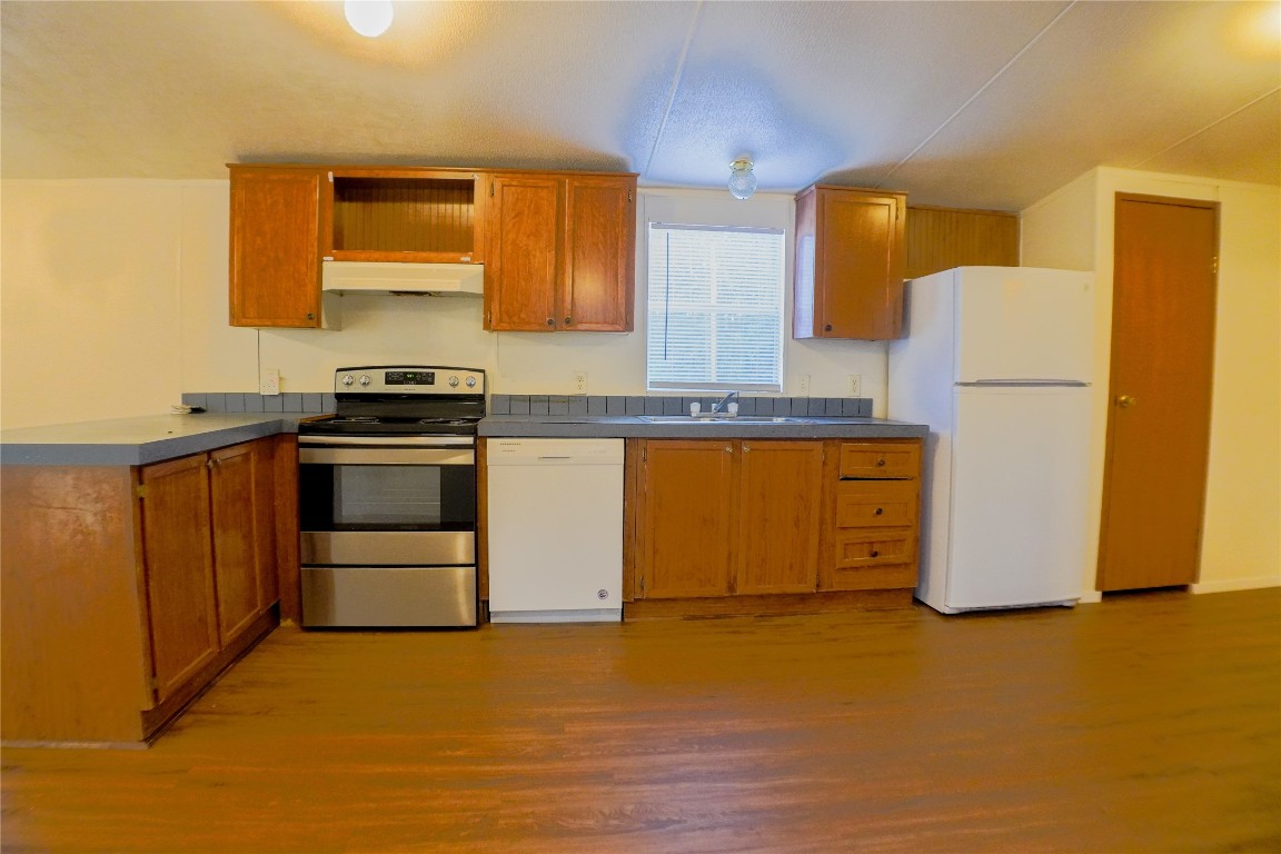 3408 Old Houston Road Huntsville, TX 77340 - Photo 7 of 10 a kitchen with a sink a stove and a refrigerator