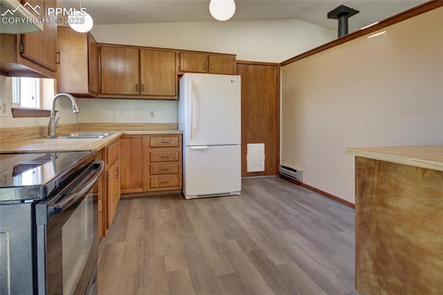 18535 Sage Crest Road Peyton, CO 80831 - Photo 11 of 24 The door to the garage is next to the refrigerator