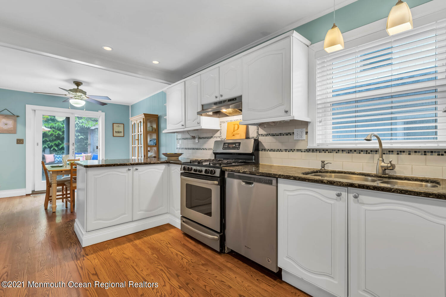 294 Spring Street Red Bank, NJ 07701 - Photo 8 of 21 a kitchen with granite countertop a stove a sink a dining table and chairs