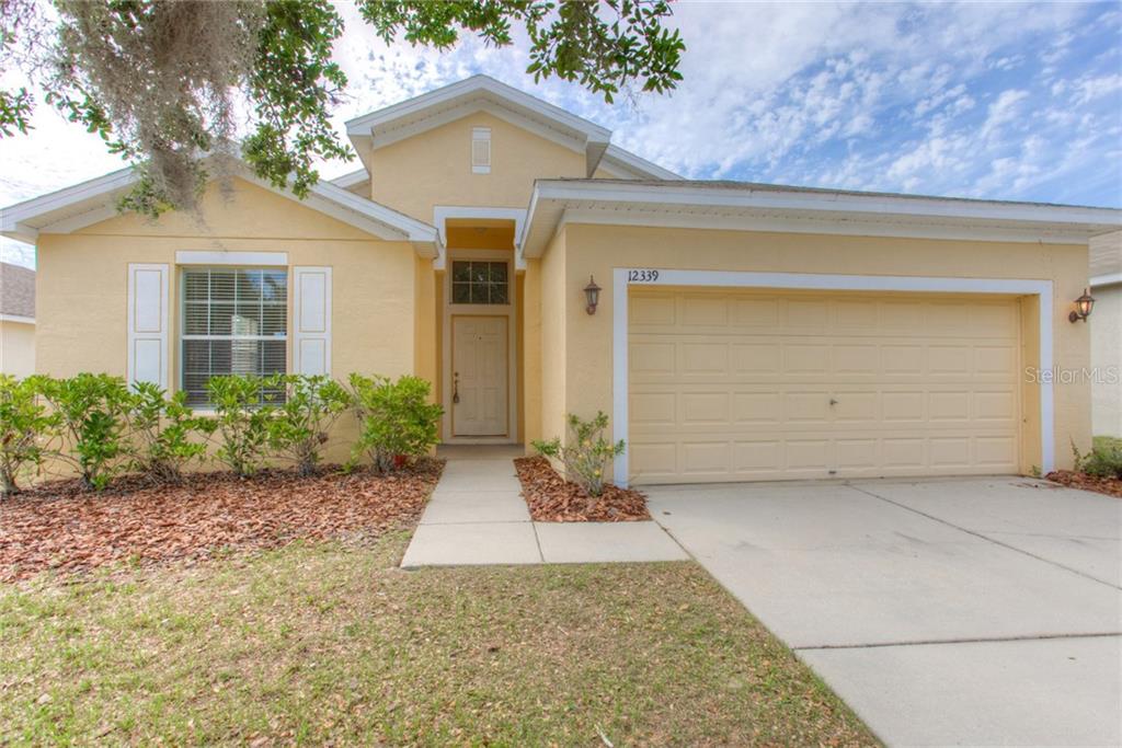 12339 Ridgedale Drive Hudson, FL 34669 - Photo 1 of 1 a front view of a house with garden