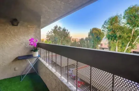 a view of balcony with wooden floor