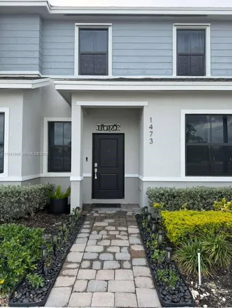 a view of a backyard with plants and wooden fence
