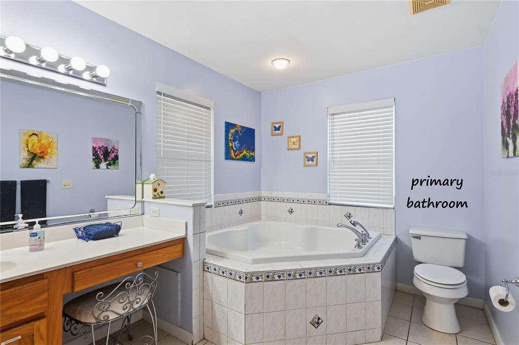 22205 North County Road 349 O'Brien, FL 32071 - Photo 11 of 73 a bathroom with a granite countertop sink a toilet a bathtub and mirror