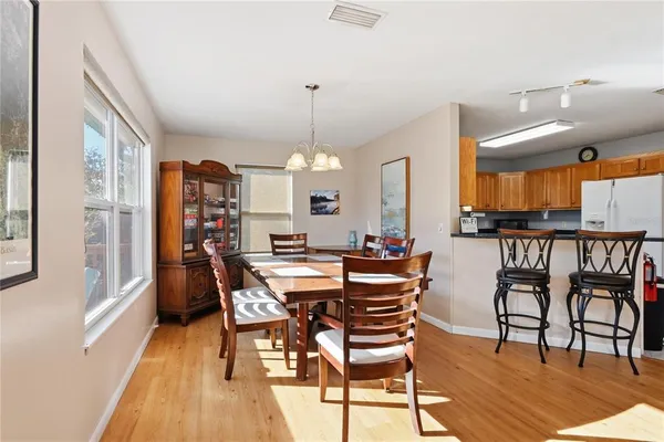 a spacious bathroom with a double vanity sink a large mirror a shower and a