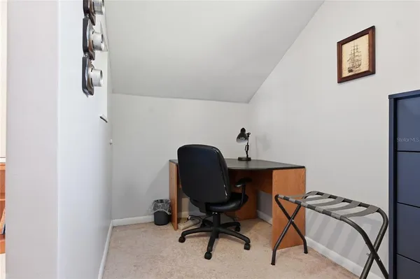 a view of a house with brick walls and potted plants