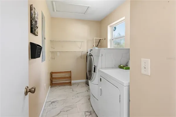 a view of house with backyard and trees
