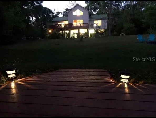 a view of a house with backyard and porch