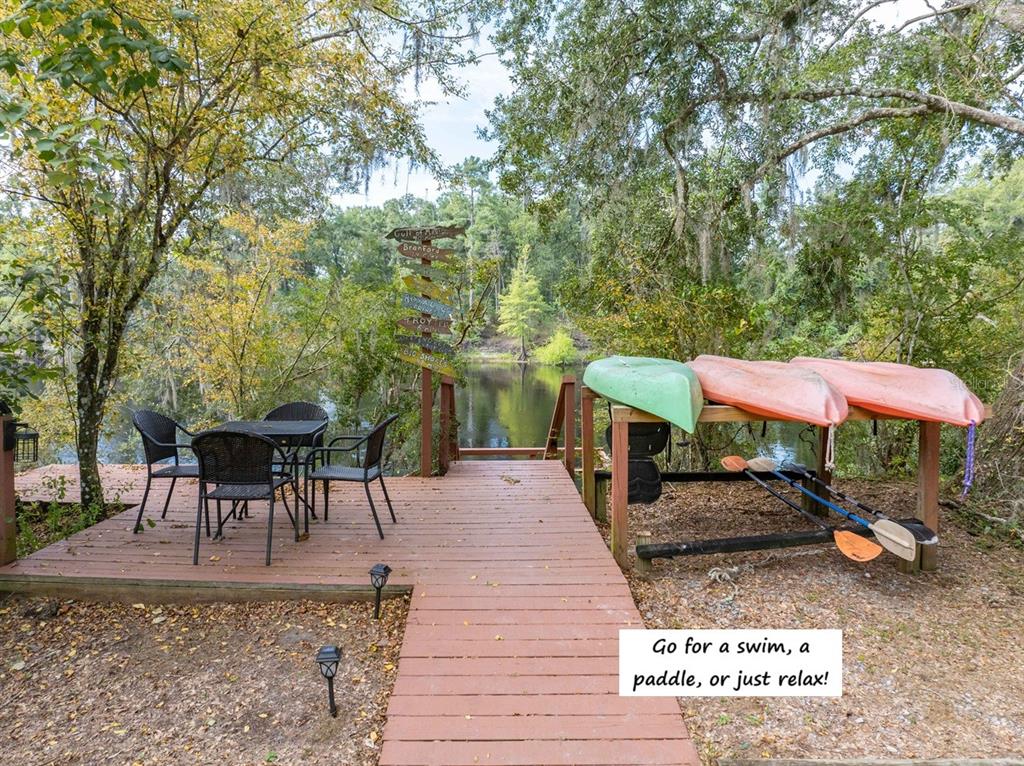 22205 North County Road 349 O'Brien, FL 32071 - Photo 33 of 73 a view of a patio with a table and chairs under an umbrella