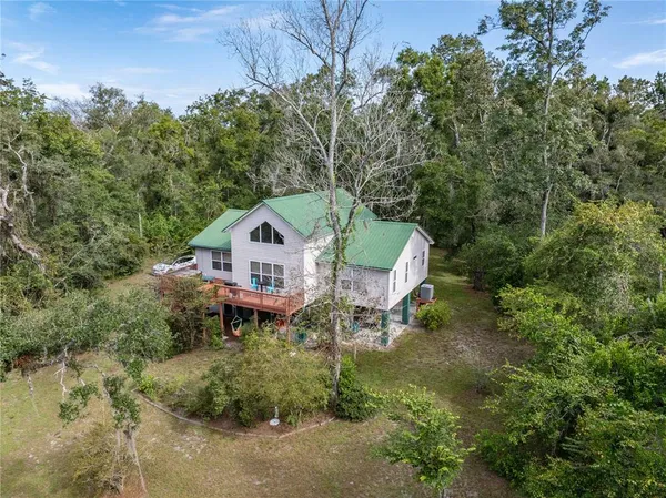 a living room with furniture and large windows