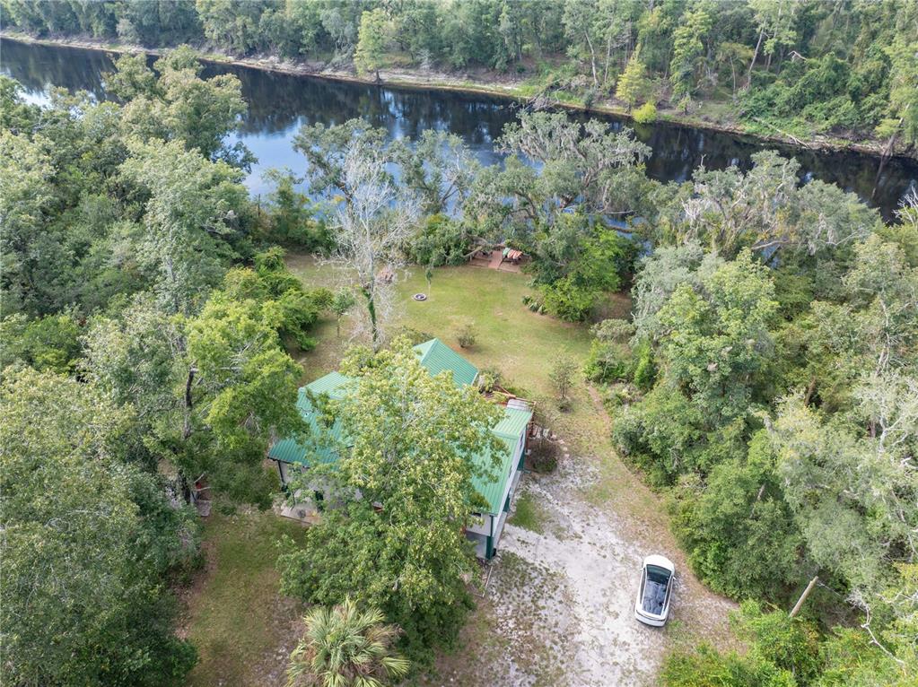 22205 North County Road 349 O'Brien, FL 32071 - Photo 5 of 68 a view of a lake with large trees