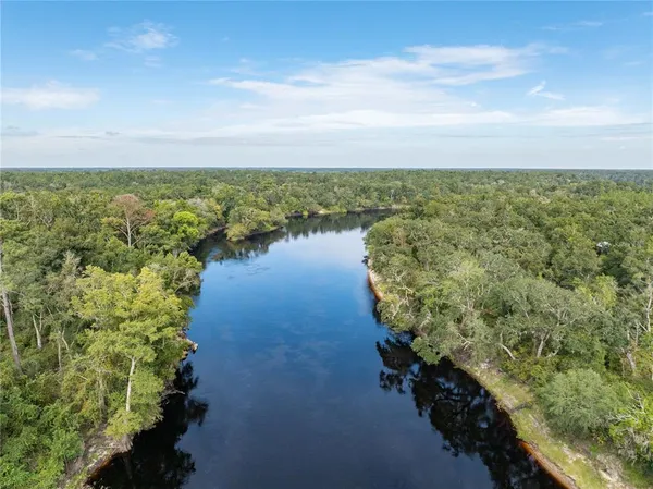 a living room with furniture a rug and a chandelier
