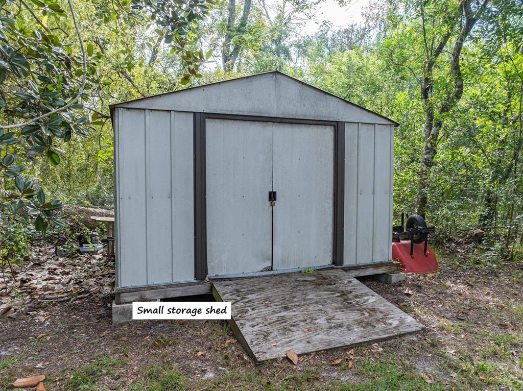 22205 North County Road 349 O'Brien, FL 32071 - Photo 73 of 73 a wooden bench sitting in front of a house