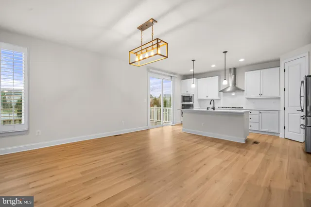 a view of kitchen with wooden floor and window