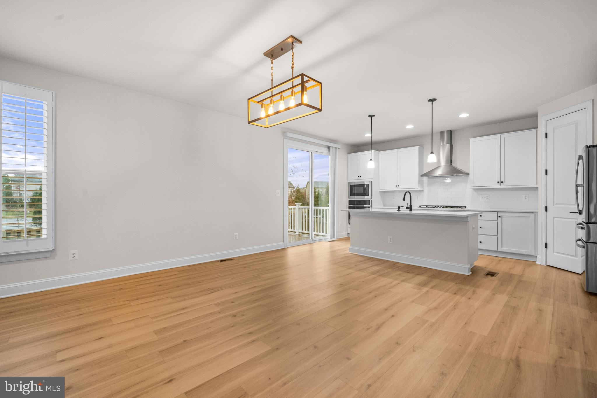 9516 Kimbleton Hall Loop Manassas Park, VA 20111 - Photo 11 of 51 a view of kitchen with wooden floor and window
