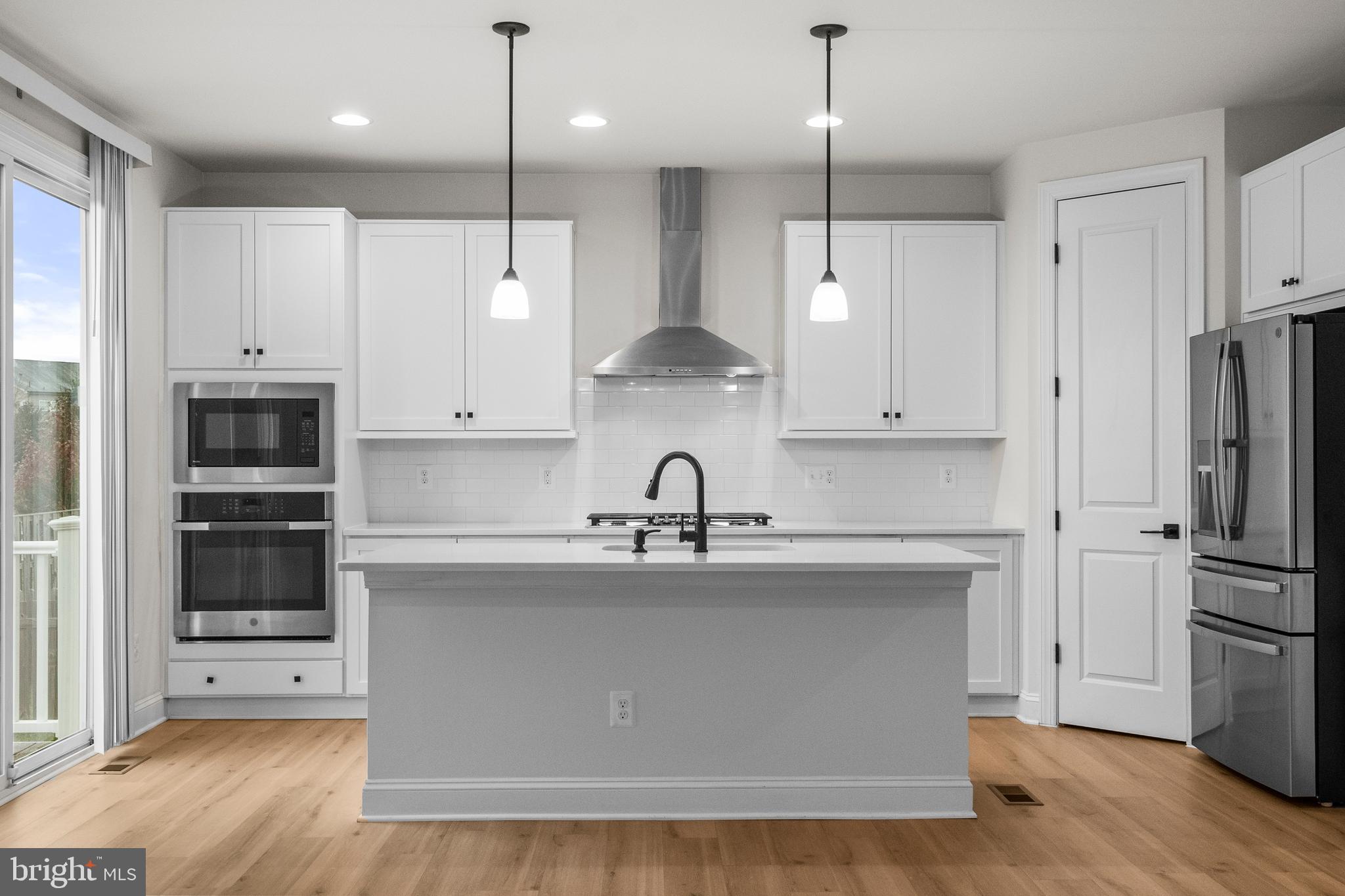 9516 Kimbleton Hall Loop Manassas Park, VA 20111 - Photo 13 of 51 a kitchen with stainless steel appliances granite countertop a refrigerator a sink and white cabinets