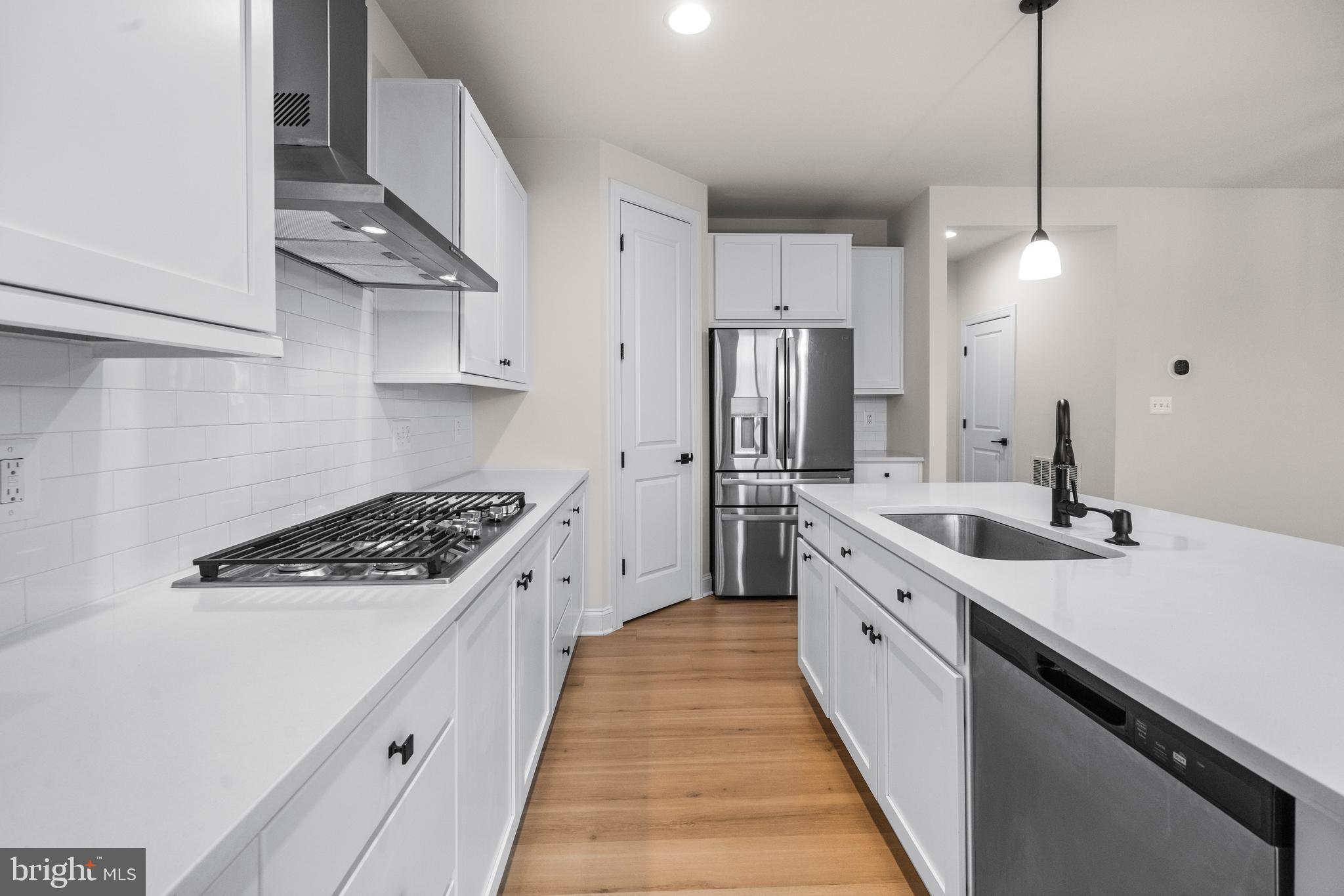 9516 Kimbleton Hall Loop Manassas Park, VA 20111 - Photo 14 of 51 a kitchen with stainless steel appliances a sink stove and refrigerator