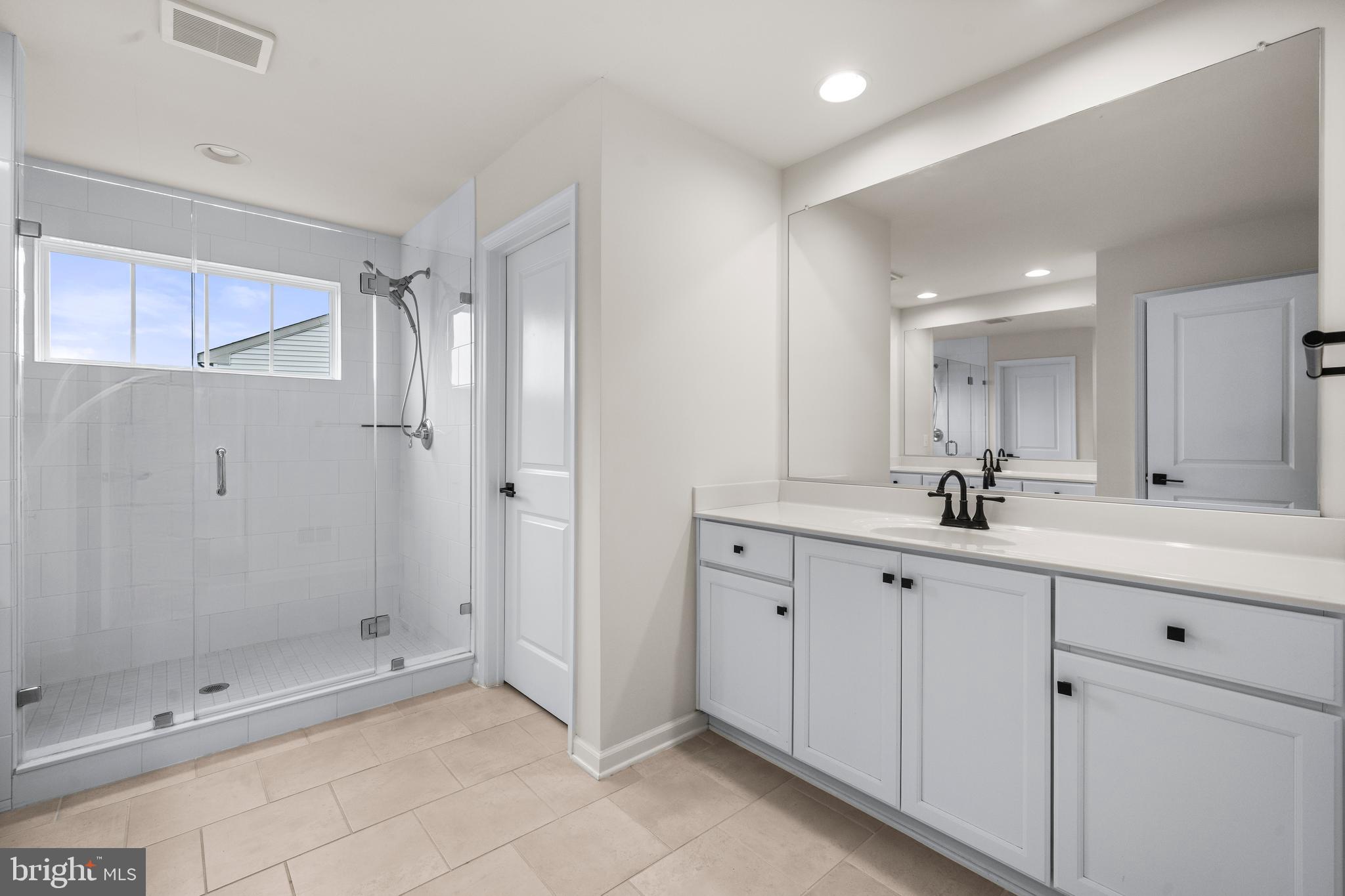 9516 Kimbleton Hall Loop Manassas Park, VA 20111 - Photo 24 of 51 a bathroom with a shower sink and mirror