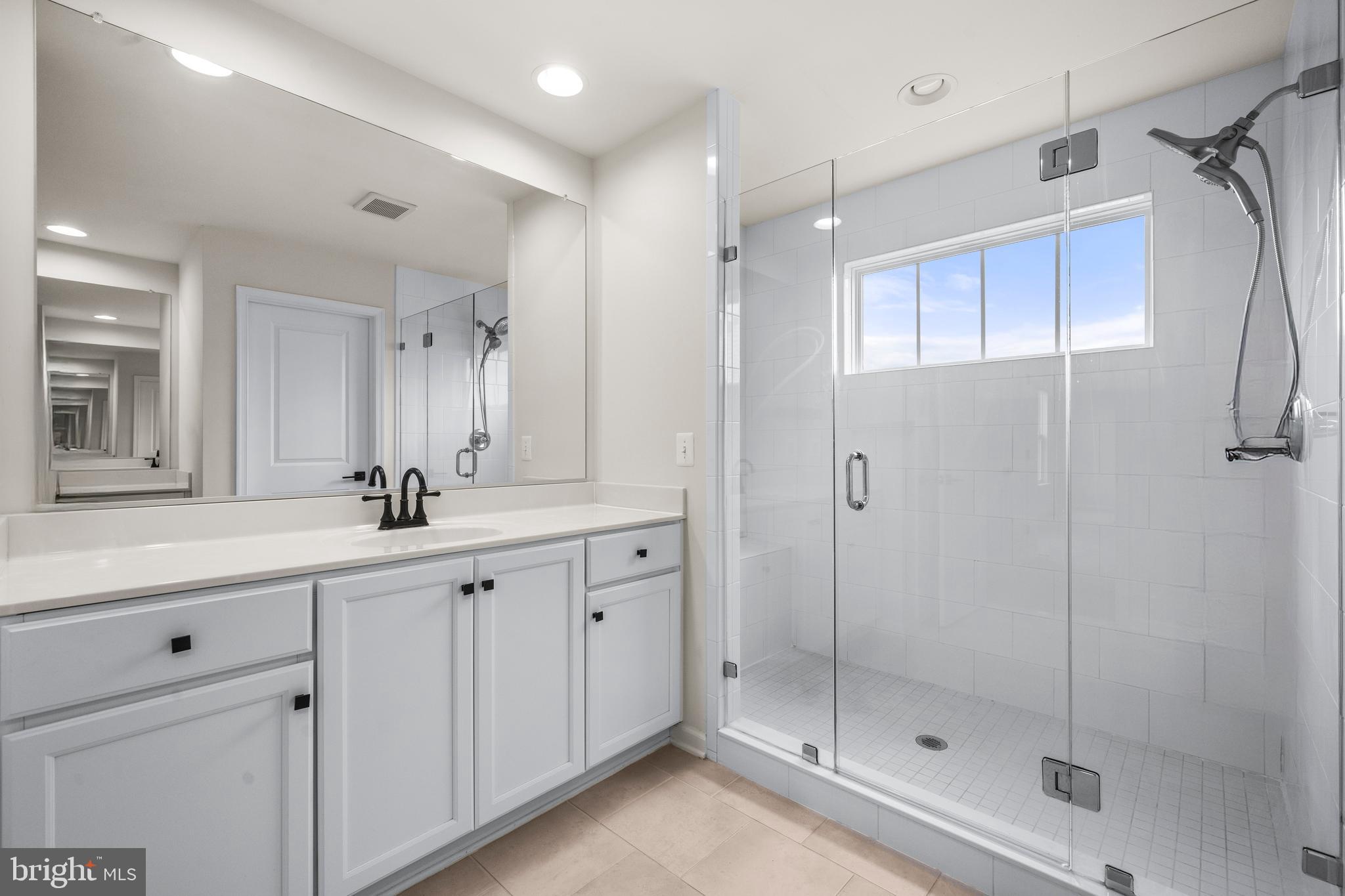 9516 Kimbleton Hall Loop Manassas Park, VA 20111 - Photo 25 of 51 a bathroom with a shower sink and mirror