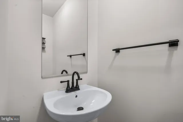 a bathroom with a sink and mirror