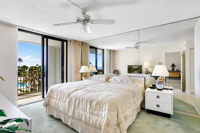 a bed room with a bed mirror and a window