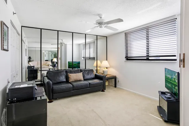 a living room with furniture and large windows